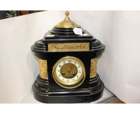 A late 19th Century black slate mantle clock, circular white enamel dial, Arabic numerals, twin winding holes, gilt metal det