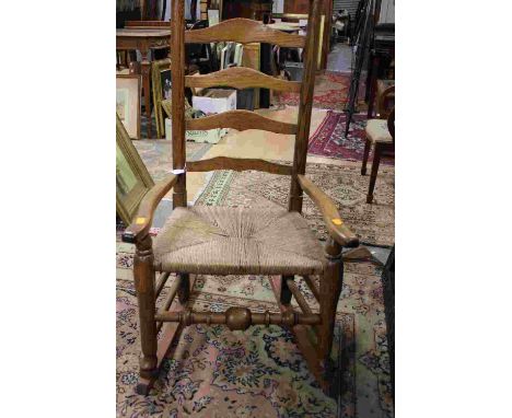 A 19th Century ash rush seated ladder back rocking chair, of Regional design 