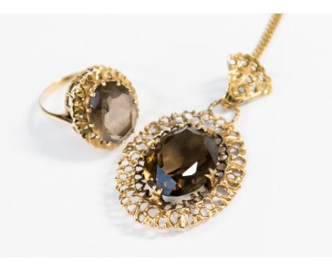 Two 9ct. gold smoky quartz set jewellery items comprising a dress ring, size R and a pendant and chain, gross weight approx 1