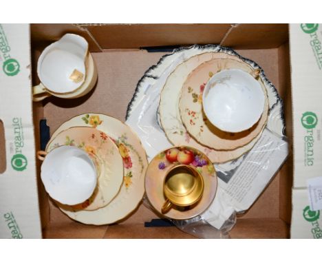 A Royal Worcester coffee can and saucer, painted with fruit, signed C.Bowen; two Royal Worcester blush ivory trios and milk j