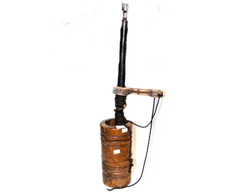 Nepalese butter churn in carved wood.