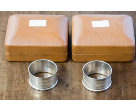 A pair of cased Sheffield engine turned napkin rings, engraved initials 1976
