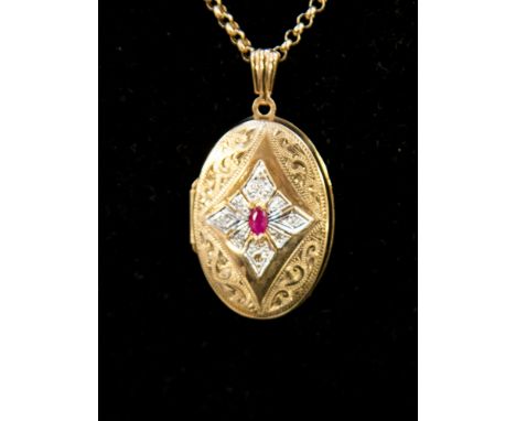 A 9ct gold oval locket on fine chain, set oval cut ruby to the front, approx 8 grams 