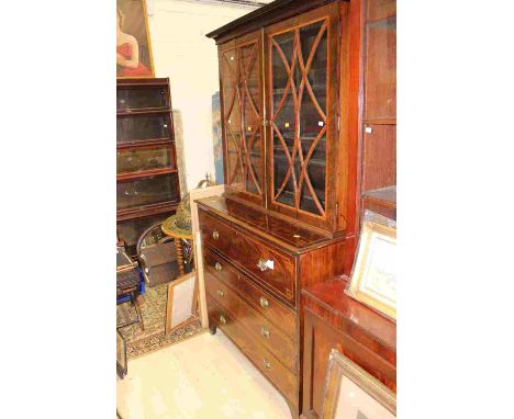 A George III mahogany secretaire bookcase, the upper section with two glazed doors enclosing adjustable shelves, the base wit