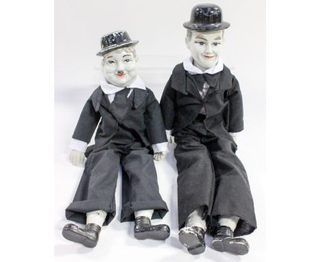 Circa 1940s dolls of Laurel & Hardy, both having ceramic heads, feet and hands, soft bodies