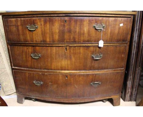 An early 19th Century bow fronted mahogany chest of drawers, fitted with three long drawers, raised on bracket feet