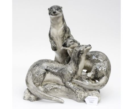 A Peggy Davis ceramic sculpture of a group of grey otters