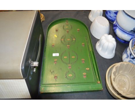 A green painted bagatelle board 