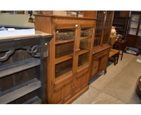 An Ercol glazed cabinet 