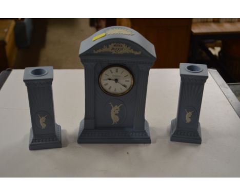 A Wedgwood jasperware mantel clock; with a pair of matching candlesticks 