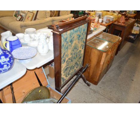 A Victorian mahogany pull-up fire screen with embroidered panels 