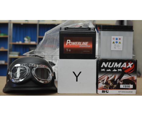2 Motorcycle batteries together with a German Motorcycle helmet
