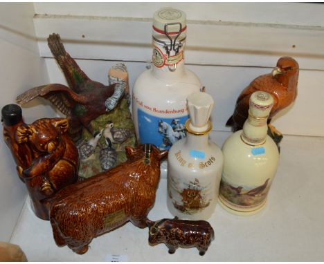 8 assorted ceramic whiskey decanters, most with original contents