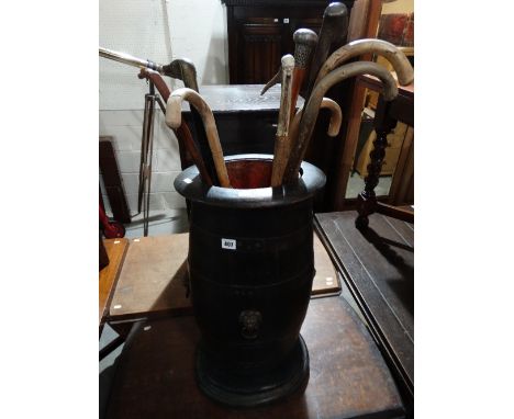 A Barrel Style Stick Stand And Sticks
