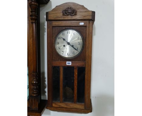 An Early 20th Century Polished Oak Encased Pendulum Wall Clock