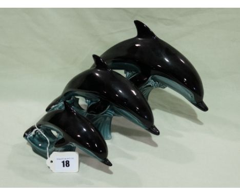 A Graduated Set Of Three Poole Pottery Swimming Dolphins
