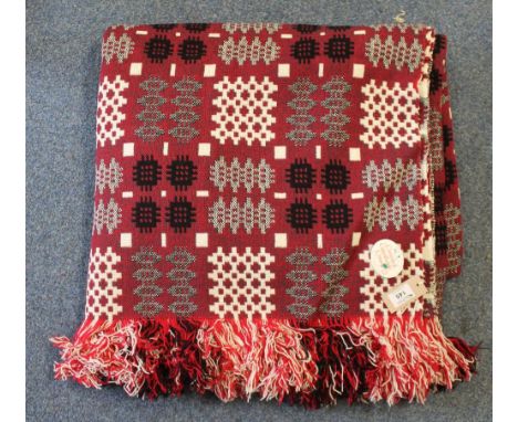 A vintage red ground Welsh tapestry blanket with fringed edging with a 'Made in Mid Wales' label attached. (B.P. 24% incl. VA