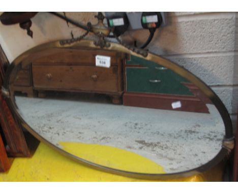 Early 20th Century oval brass framed bevel plate mirror with classical urn finial. (B.P. 24% incl. VAT)