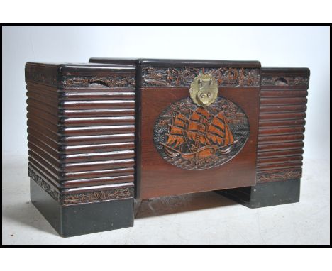 A mid century camphor wood Chinese influenced blanket box chest of unusual ribbed form having central carved in relief cartou