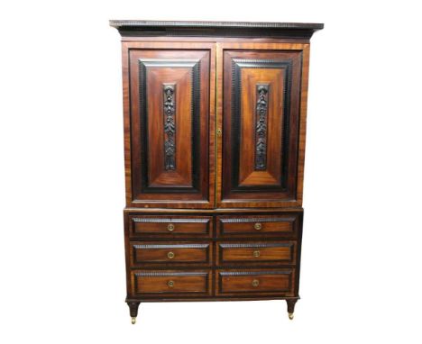 Early 19th century Dutch colonial hardwood and ebonised linen press, with ripple moulded cornice and enclosed by pair of fiel