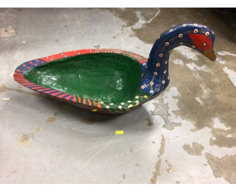 A decorative papier-mâché goose and ceramic two faced dogs head