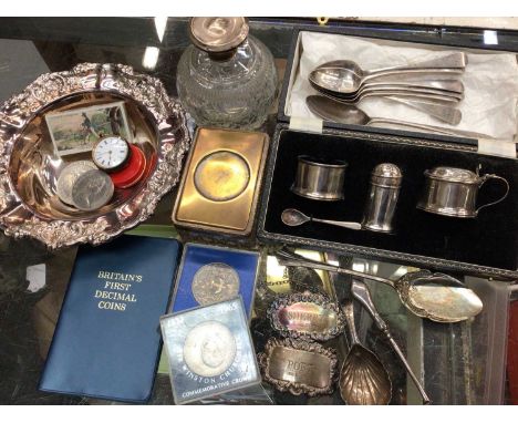 Silver cruet set in case, silver teaspoons, silver caddy spoon, two silver spirit labels, silver topped glass scent bottle an