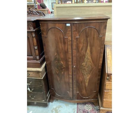 Georgian-style Bowfront cabinet with two doors enclosing adjustable shelves on splayed bracket feet 87 cm wide, 144 cm high