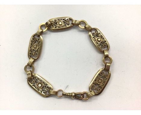 9ct gold oval panel bracelet with star and pierced scroll design Condition report: Weight 19.6 grams. Length 21.7cm.Overall c