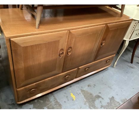 Ercol sideboard with three cupboards and two drawers below, 129cm wide, 43cm deep, 76cm high