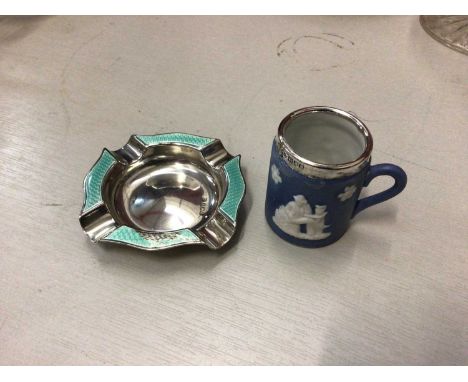 Silver and enamel ashtray, together with a miniature Wedgwood silver mounted mug (2)