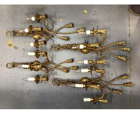Four gilt tasselled rope style electric three branch wall sconces, with candle drip light bulb fittings
