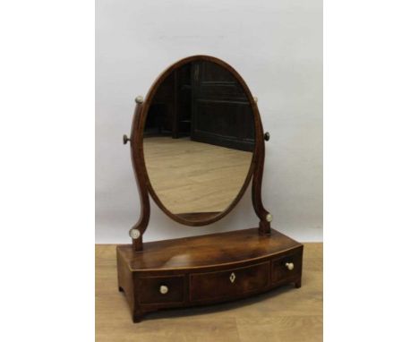 Regency mahogany bowfront swing frame toilet mirror, worth oval plate raised between shaped supports and three drawers to the