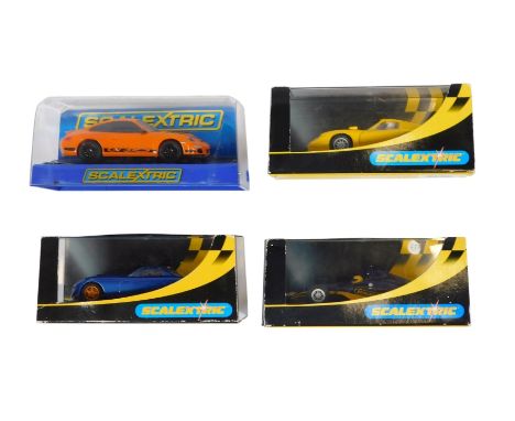 Four Scalextric racing cars, comprising C2449 Porsche GT1, C2606 Dallara Indie, C2363 TVR Speed 12, and C2871 Porsche 997 ora