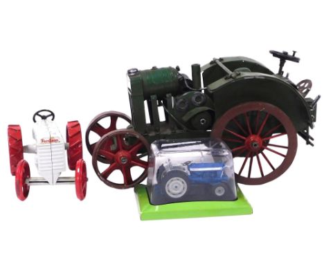 A tin plate John Deere tractor, together with a diecast Fordson tractor, and a Hachette Ford 5000 tractor, boxed. (3)