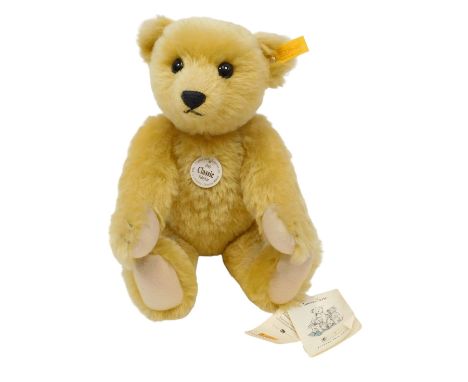 A Steiff 1909 Classic Teddy bear, mohair with felt pads and glass eyes, 35cm tall. 