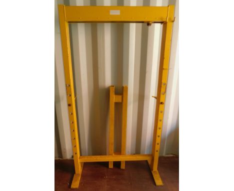 A yellow bearing press frame. 
