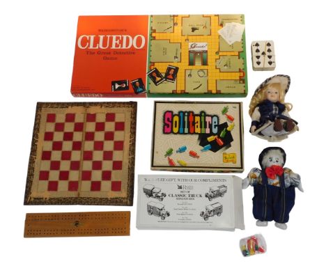 Games and dolls, including Waddington's Cluedo, Berwick Solitaire, cribbage board, clown doll with china head, hands and feet