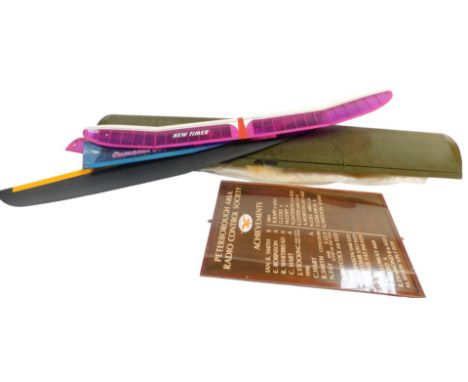 Various model plane wings, and a Peterborough Area Radio Control Society achievements board. 