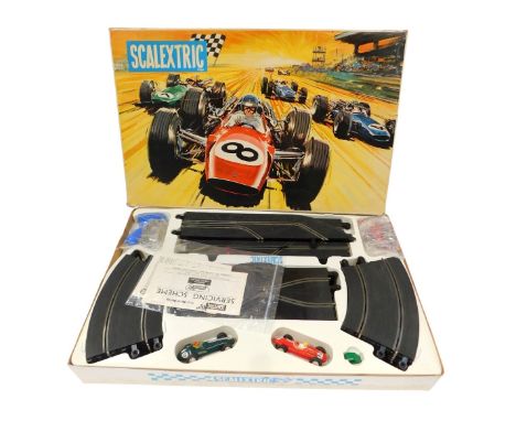 A Scalextric Grand Prix 75 racing set.