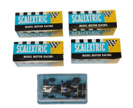 Four Scalextric model motor racing classic cars, in modern boxes, and a JPS F1 Scalextric car.