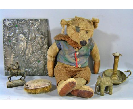 A miscellaneous collection of items including an old thread bare Teddy Bear in a tartan waistcoat, a small statue of Napoleon