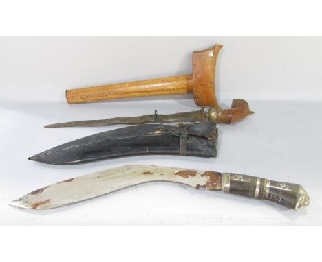 An Indian Kukris type dagger in a leather sheath, India engraved to the rusting blade, and an Indonesian Kris type dagger wit