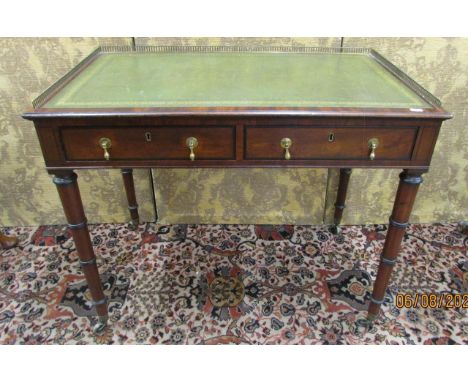 A small Regency mahogany writing table with two frieze drawers on turned and ringed supports, with inset leather top and thre