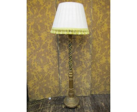 A good quality standard lamp, the carved barbola and gilded detail, entwined with rose garland, raised on a circular base wit