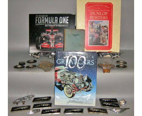 Car memorabilia, mainly Jaguar car badges and logos, together with racing car related books.