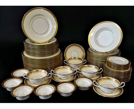A large quantity of Minton porcelain dinnerware in cream with gilt edged borders comprising 12 dinner plates, 11 side plates,