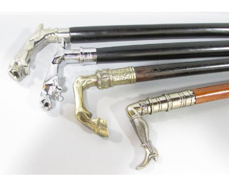 Two ebony canes with chrome leaping Jaguar handles, an ebony cane with a brass horse’s lower leg and hoof, and a fourth Edwar