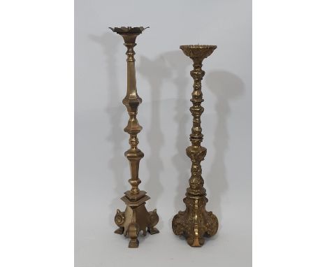 A heavy antique ecclesiastical brass pricket candlestick in the old English style, with tapering turned stem raised on scroll