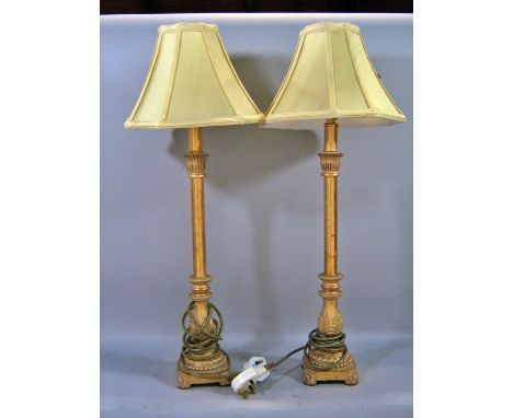 A pair of wooden turned table lamps and a pair of candlestick table lamps, all with shades.