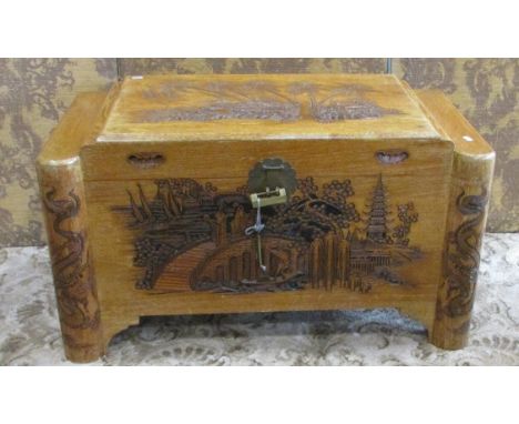 A Chinese intricately carved camphor wood trunk, 93cm wide.